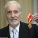 Cool-Dude-Bad-Ass-From-Birth Christopher Lee: World War II Secret Agent, Wizard, Jedi, Heavy Metal Singer, and all-around British Demi-God, holding the rare-but-Universally-acknowledged “I Rule You” Medal.